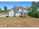 Back of home showcasing the expansive lawn and outdoor wooden deck at 3790 Chattahoochee (Lot 33) Rd, Cumming, GA 30041