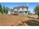 Back of home showcasing the expansive lawn and outdoor wooden deck at 3790 Chattahoochee (Lot 33) Rd, Cumming, GA 30041