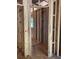 View of the interior framing of the house under construction with exposed wood studs and beams at 3790 Chattahoochee (Lot 33) Rd, Cumming, GA 30041