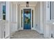 Charming blue front door with glass panes and brick porch at 3790 Chattahoochee (Lot 33) Rd, Cumming, GA 30041