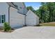 Spacious detached garage featuring multiple bays and a concrete driveway, surrounded by greenery at 3790 Chattahoochee (Lot 33) Rd, Cumming, GA 30041