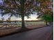 Picturesque view of a sprawling green golf course with a tree-lined street, and gorgeous sunset at 3790 Chattahoochee (Lot 33) Rd, Cumming, GA 30041