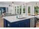 Bright, modern kitchen with stainless steel appliances and a large island with quartz countertops at 3790 Chattahoochee (Lot 33) Rd, Cumming, GA 30041