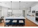 Contemporary kitchen with white cabinets, large island with seating, stainless steel appliances, and modern fixtures at 3790 Chattahoochee (Lot 33) Rd, Cumming, GA 30041