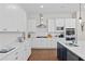 Gourmet kitchen with white cabinets, quartz countertops, stainless steel appliances, and hardwood flooring at 3790 Chattahoochee (Lot 33) Rd, Cumming, GA 30041