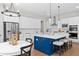 Modern kitchen featuring white cabinetry, stainless steel appliances, and a striking blue island with seating at 3790 Chattahoochee (Lot 33) Rd, Cumming, GA 30041