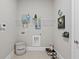 Functional laundry room with wire shelving, tile floors, and a charming dog bed at 3790 Chattahoochee (Lot 33) Rd, Cumming, GA 30041