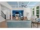 Open-concept living area flows seamlessly, highlighted by large windows and a cozy fireplace with hardwood flooring at 3790 Chattahoochee (Lot 33) Rd, Cumming, GA 30041