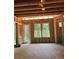 Living room under construction with window and door framing, awaiting finishing with view of the backyard at 3790 Chattahoochee (Lot 33) Rd, Cumming, GA 30041