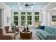 Sunlit living room featuring many windows and comfortable seating, perfect for relaxing or entertaining guests at 3790 Chattahoochee (Lot 33) Rd, Cumming, GA 30041