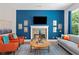 Bright living room boasts a fireplace, large windows, and comfortable seating with hardwood flooring at 3790 Chattahoochee (Lot 33) Rd, Cumming, GA 30041