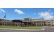 Exterior of the school building with covered walkways and lawn at 3790 Chattahoochee (Lot 33) Rd, Cumming, GA 30041