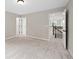 Spacious bedroom featuring neutral walls, carpet, and a view to an upstairs landing at 3790 Chattahoochee Rd, Cumming, GA 30041