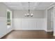 Dining room featuring wainscoting, hardwood floors, and a coffered ceiling at 3790 Chattahoochee (Lot 33) Rd, Cumming, GA 30041