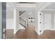 View of the foyer with hardwood floors, a staircase, and an open floor plan at 3790 Chattahoochee (Lot 33) Rd, Cumming, GA 30041