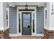 Close-up of the front door, showing the sidelights, transom window, and brick accents at 3790 Chattahoochee Rd, Cumming, GA 30041