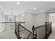 Hallway featuring dark wood railing and black metal spindles at 3790 Chattahoochee Rd, Cumming, GA 30041