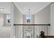 Hallway with railing overlooking the stairwell at 3790 Chattahoochee Rd, Cumming, GA 30041