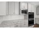 Close up of kitchen with marble countertops, stainless steel appliances, and modern finishes at 3790 Chattahoochee Rd, Cumming, GA 30041