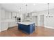 Kitchen boasts a blue island, modern appliances, and bright white cabinetry at 3790 Chattahoochee Rd, Cumming, GA 30041