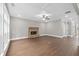 Spacious living room featuring a stone fireplace, hardwood floors, and coffered ceiling at 3790 Chattahoochee Rd, Cumming, GA 30041