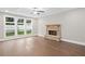 Living room with a stone fireplace, hardwood floors, and a large window at 3790 Chattahoochee Rd, Cumming, GA 30041