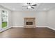 Bright living room with coffered ceiling, hardwood floors, and a stone fireplace at 3790 Chattahoochee (Lot 33) Rd, Cumming, GA 30041