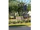 Neighborhood entrance featuring landscaping, signage, and stone columns at 3790 Chattahoochee Rd, Cumming, GA 30041