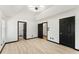 This main bedroom has wood floors, white walls, and black door and window trim at 71 Riverside Ct, Douglasville, GA 30134