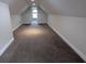 Finished carpeted attic featuring neutral walls and trim at 1205 Peeksville Rd, Locust Grove, GA 30248