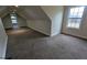 View of the home's carpeted attic with neutral walls, trim and window at 1205 Peeksville Rd, Locust Grove, GA 30248