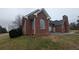 Side view of brick house featuring large arch window and a patio at 1205 Peeksville Rd, Locust Grove, GA 30248