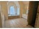 Bathroom featuring tiled flooring, a jacuzzi tub, and a large vanity with elegant features at 1205 Peeksville Rd, Locust Grove, GA 30248