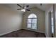 Bedroom with vaulted ceiling, carpeted floors, and a large arched window at 1205 Peeksville Rd, Locust Grove, GA 30248