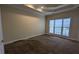 Bedroom featuring carpeted floors, tray ceiling, and large window that provides ample natural light at 1205 Peeksville Rd, Locust Grove, GA 30248