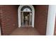 Inviting front entrance with brick facade, tiled porch and an arched glass door at 1205 Peeksville Rd, Locust Grove, GA 30248