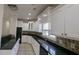 Kitchen featuring ample white cabinetry, granite countertops, and tile backsplash at 1205 Peeksville Rd, Locust Grove, GA 30248