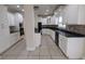 Spacious kitchen with white cabinets, black appliances, tile backsplash, and tile flooring at 1205 Peeksville Rd, Locust Grove, GA 30248