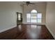 Inviting living room with gleaming hardwood floors, large windows, and high ceilings, creating a bright and airy space for gatherings at 1205 Peeksville Rd, Locust Grove, GA 30248