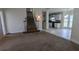 Living room with stairs leading to the second floor and kitchen in the background at 1205 Peeksville Rd, Locust Grove, GA 30248