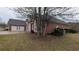 Side view of brick house featuring arched windows and a garage at 1205 Peeksville Rd, Locust Grove, GA 30248