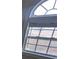 Close up of an arched grid window with white trim at 1205 Peeksville Rd, Locust Grove, GA 30248