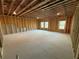 Unfinished basement with exposed beams, concrete floors, and natural light from windows at 3904 Allegretto Cir # 50, Atlanta, GA 30339