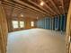 Unfinished basement with exposed beams, concrete floors, and natural light from windows at 3904 Allegretto Cir # 50, Atlanta, GA 30339