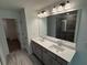 Bathroom featuring double sinks, a shower with glass doors, and a walk-in closet at 3904 Allegretto Cir # 50, Atlanta, GA 30339