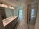 Bathroom featuring double sinks, a shower with glass doors, and modern fixtures at 3904 Allegretto Cir # 50, Atlanta, GA 30339