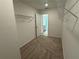 A walk-in closet leads into a bathroom with white cabinets and gray countertops at 3904 Allegretto Cir # 50, Atlanta, GA 30339