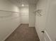 A spacious walk-in closet with wire shelving and neutral carpeting at 3904 Allegretto Cir # 50, Atlanta, GA 30339