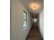 Bright hallway with hardwood floors leads to an open floor plan, filled with natural light at 3904 Allegretto Cir # 50, Atlanta, GA 30339