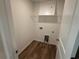 A compact laundry room has connections for a washer and dryer and overhead shelf at 3904 Allegretto Cir # 50, Atlanta, GA 30339